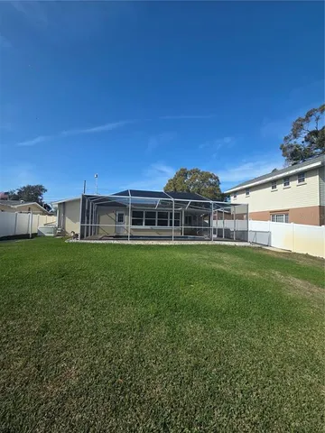 a view of a house with a backyard