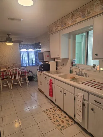a kitchen with stainless steel appliances granite countertop a sink and cabinets