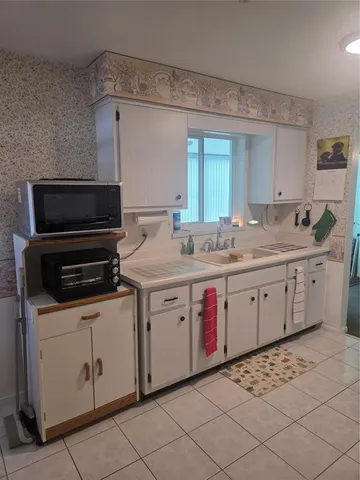 a utility room with cabinets washer and dryer