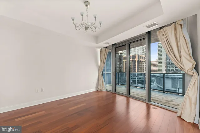 a view of a livingroom with wooden floor and a ceiling fan