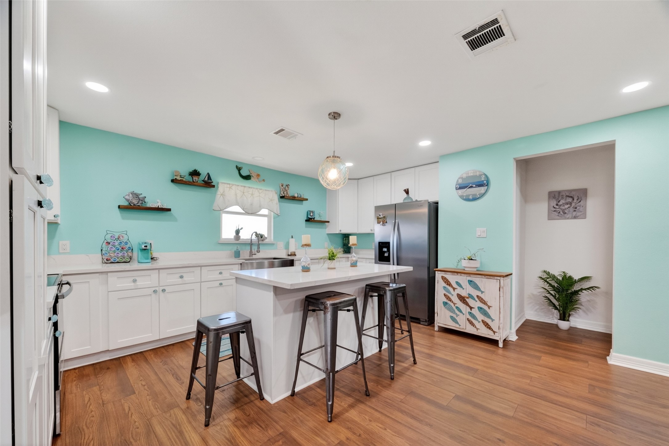 154 Poop Deck Lane Freeport, TX 77541 - Photo 11 of 32 a kitchen with stainless steel appliances a table and chairs in it