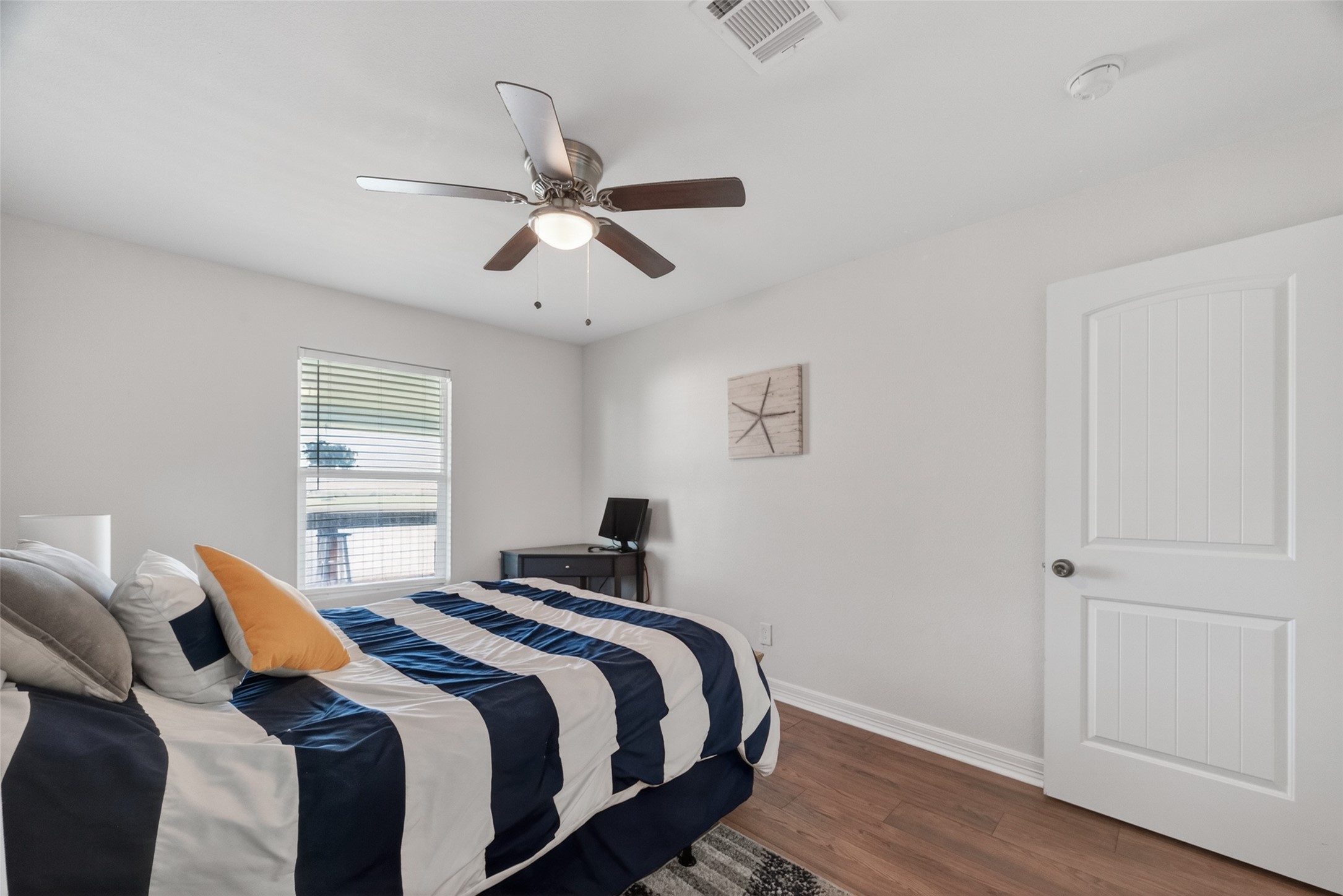 154 Poop Deck Lane Freeport, TX 77541 - Photo 13 of 32 a bedroom with a bed and wooden floor