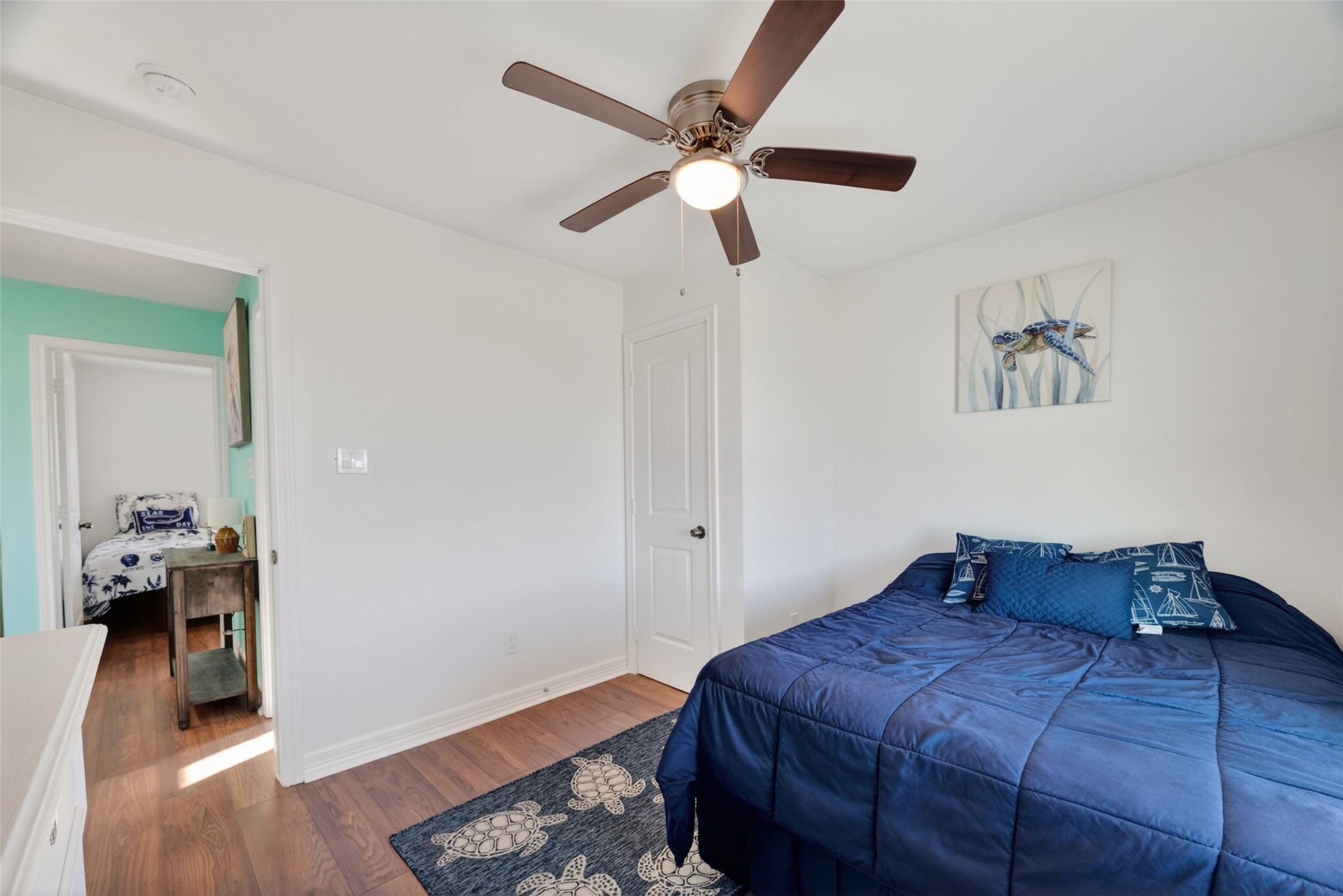 154 Poop Deck Lane Freeport, TX 77541 - Photo 17 of 32 a bedroom with a bed and wooden floor
