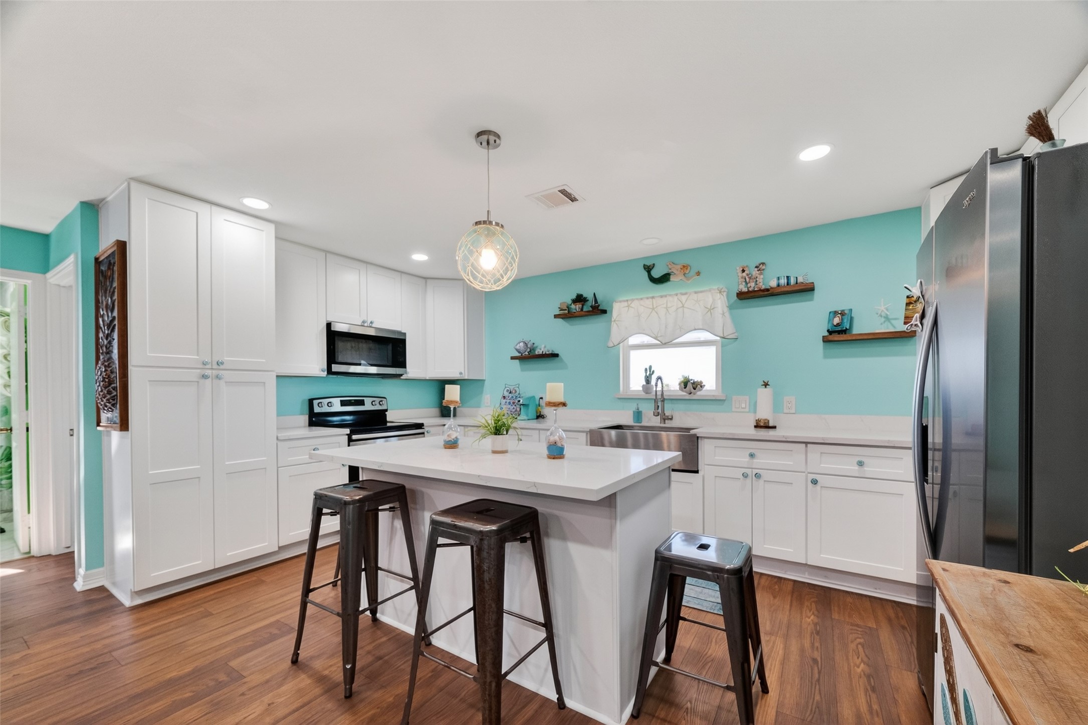 154 Poop Deck Lane Freeport, TX 77541 - Photo 6 of 32 a kitchen with stainless steel appliances a table and chairs in it