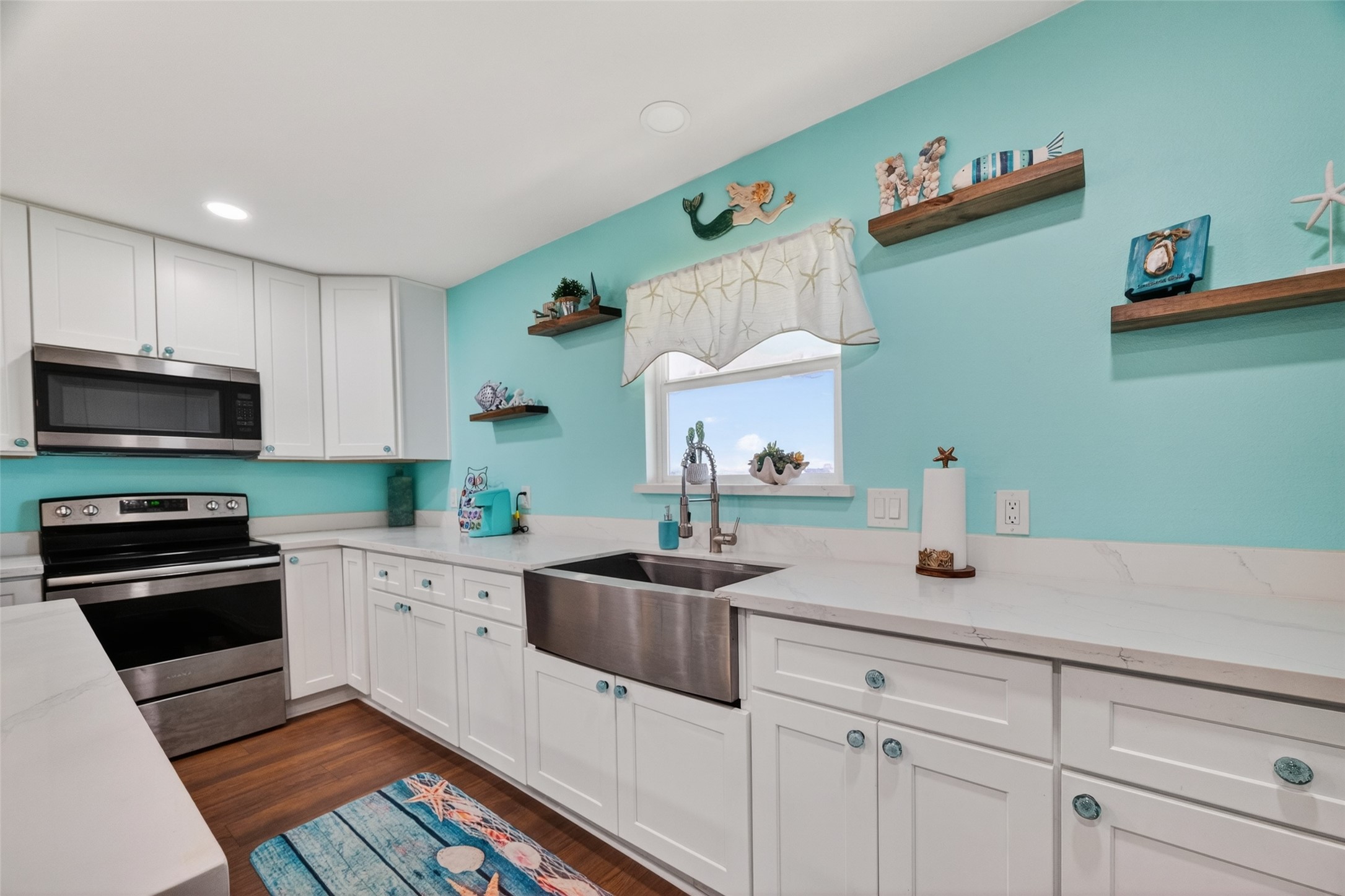 154 Poop Deck Lane Freeport, TX 77541 - Photo 7 of 32 a kitchen with a sink cabinets and wooden floor