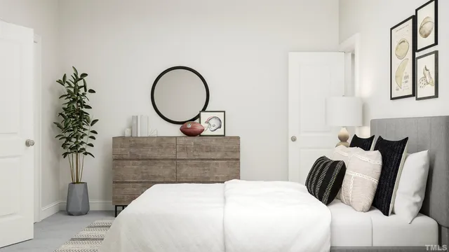 a bedroom with bed and a potted plant