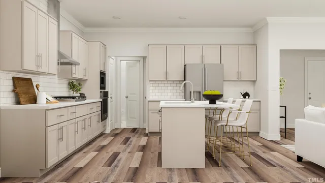 a kitchen with a refrigerator and white cabinets