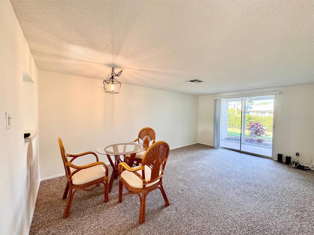 3422 Trophy Boulevard New Port Richey, FL 34655 - Photo 5 of 21 a view of a dining room with furniture and a window