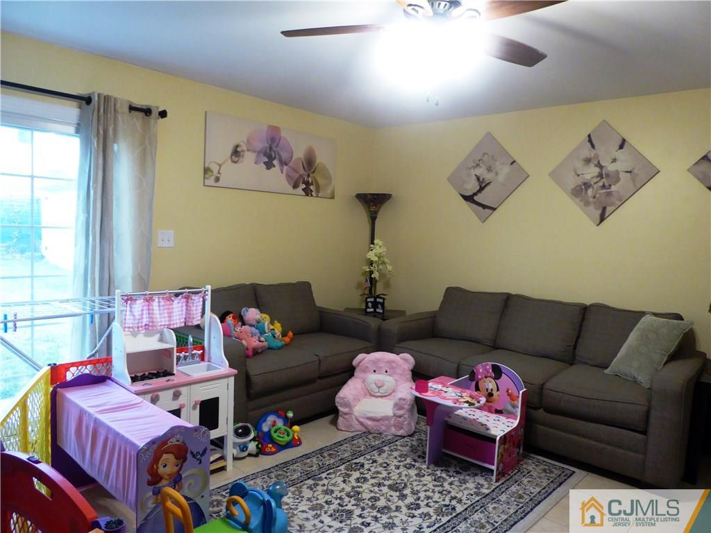 38 Crescent Road Edison, NJ 08817 - Photo 11 of 18 a living room with furniture and a rug