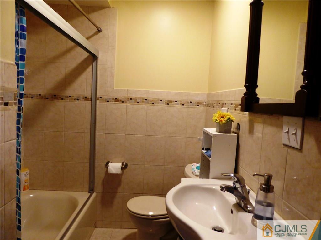 38 Crescent Road Edison, NJ 08817 - Photo 13 of 18 a bathroom with a sink a toilet and shower