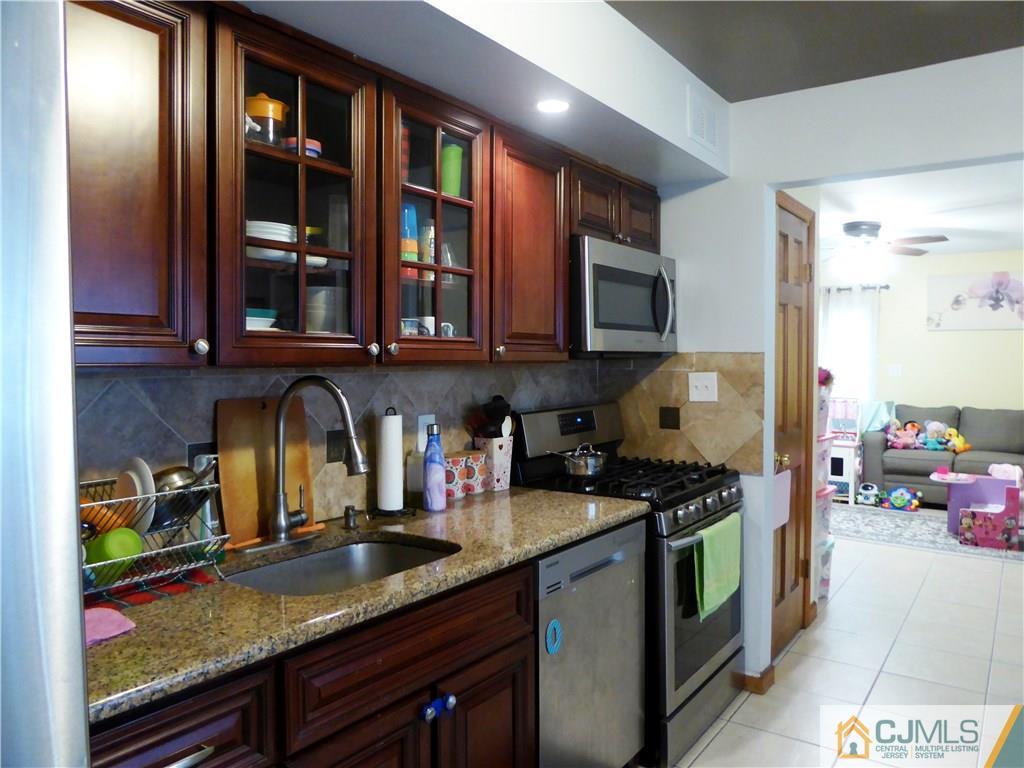 38 Crescent Road Edison, NJ 08817 - Photo 7 of 18 a kitchen with stainless steel appliances granite countertop a stove and cabinets