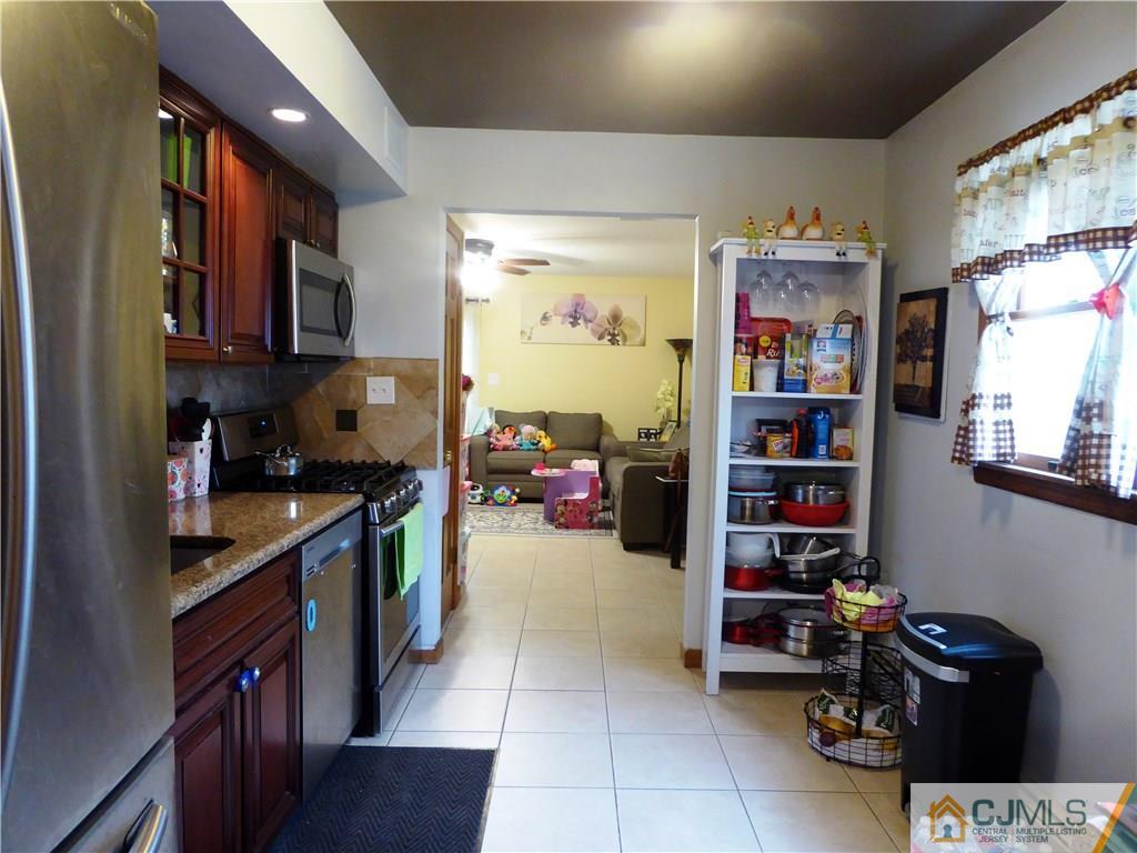 38 Crescent Road Edison, NJ 08817 - Photo 8 of 18 a kitchen with stainless steel appliances a sink and a refrigerator
