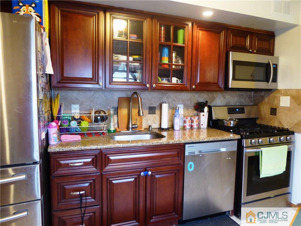 38 Crescent Road Edison, NJ 08817 - Photo 9 of 18 a kitchen with stainless steel appliances granite countertop a sink and cabinets