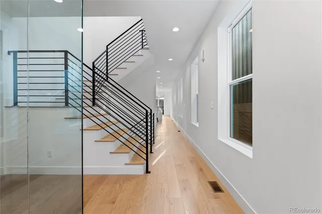 a view of entryway and hall with wooden floor