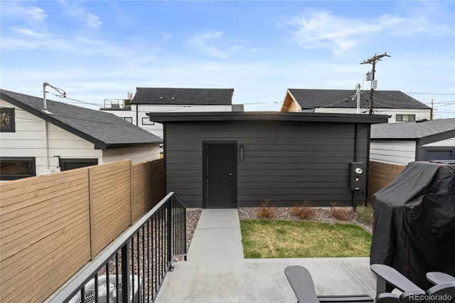 a view of a house with large windows and a table