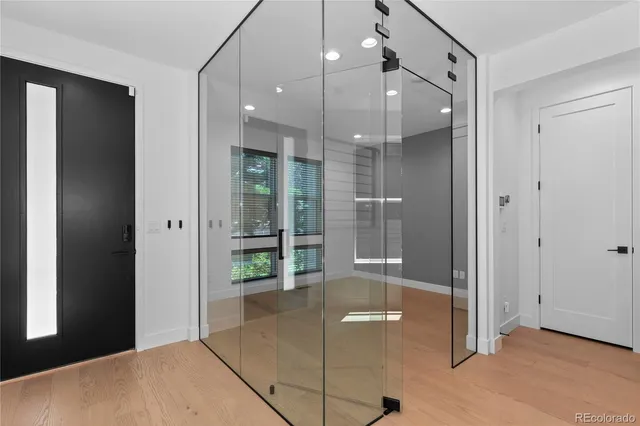 a spacious bathroom with a glass shower door and a sink