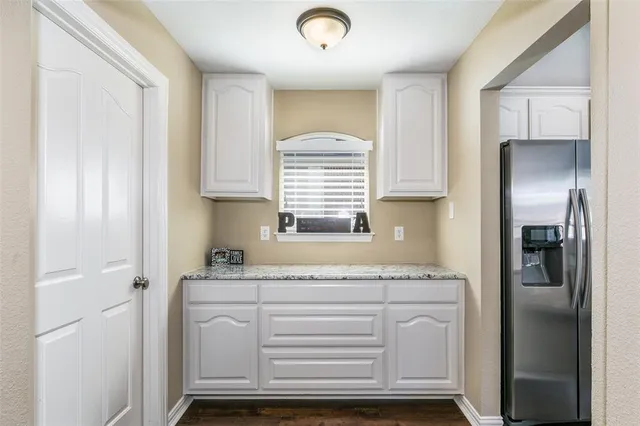 a kitchen with cabinets appliances and a window