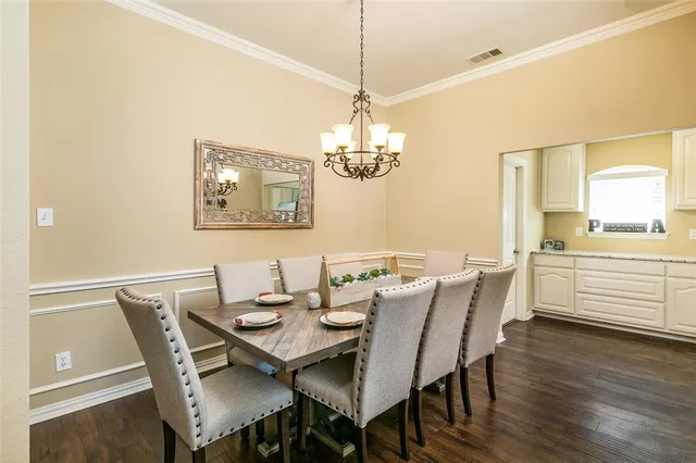a view of a dining room with furniture wooden floor and chandelier
