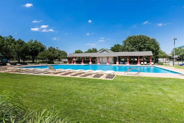 a view of house with swimming pool and outdoor space