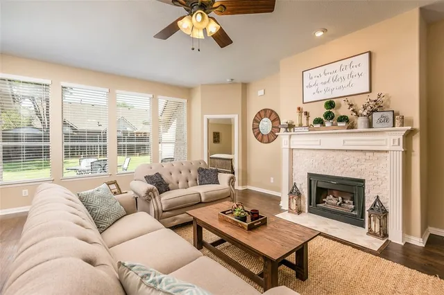 a living room with furniture fireplace and window
