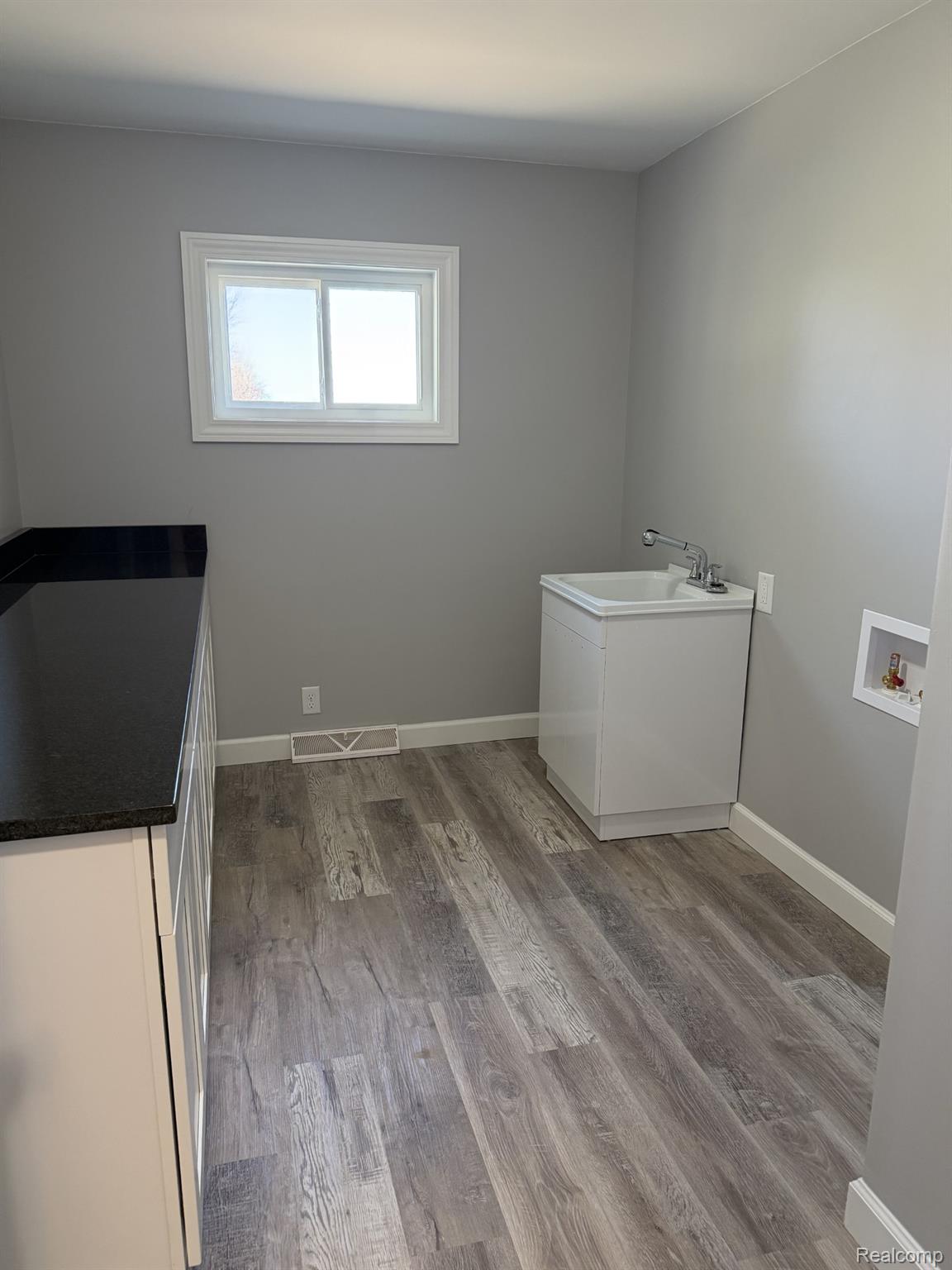 5614 West Marlette Road Marlette, MI 48453 - Photo 14 of 25 Laundry room featuring light wood-type flooring and washer hookup