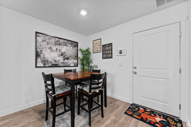 878 North Old Rnch Road Lehi, UT 84048 - Photo 12 of 36 Bright interior space featuring light wood-finish flooring, white baseboards, and a two-panel interior door