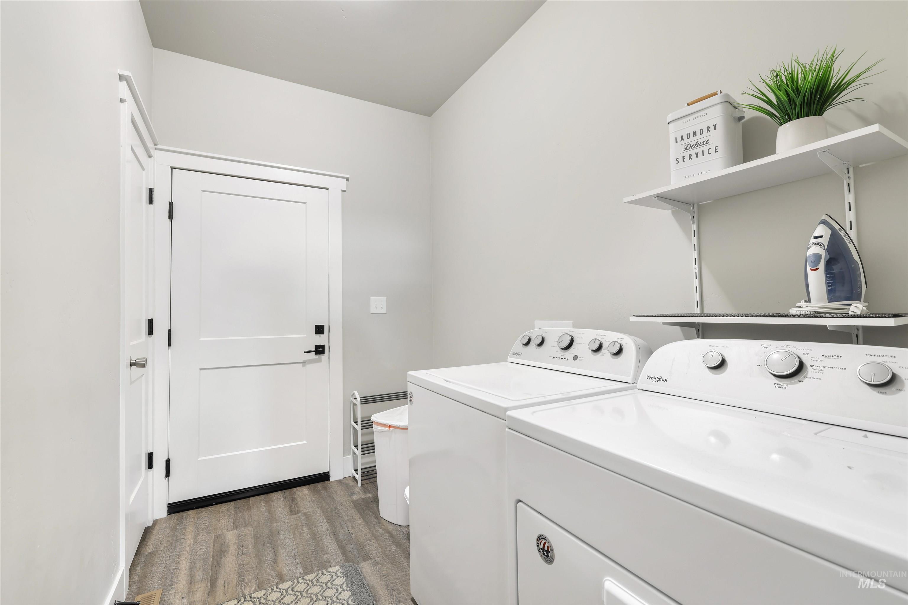 893-899 Shadowleaf Avenue Twin Falls, ID 83301 - Photo 13 of 50 Laundry room with dark wood-style flooring and washing machine and dryer