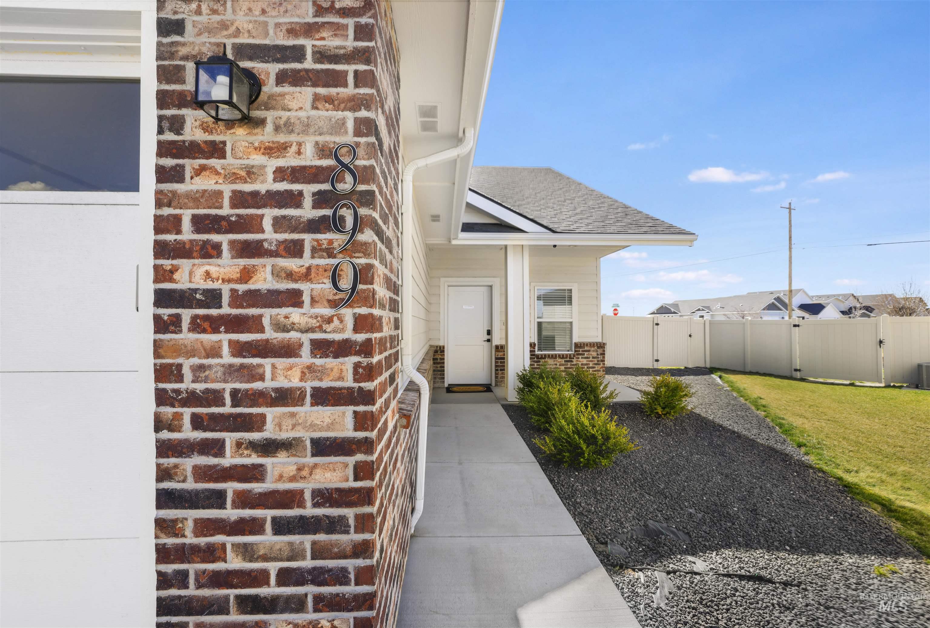 893-899 Shadowleaf Avenue Twin Falls, ID 83301 - Photo 17 of 50 Property entrance with brick siding, a gate, and a shingled roof