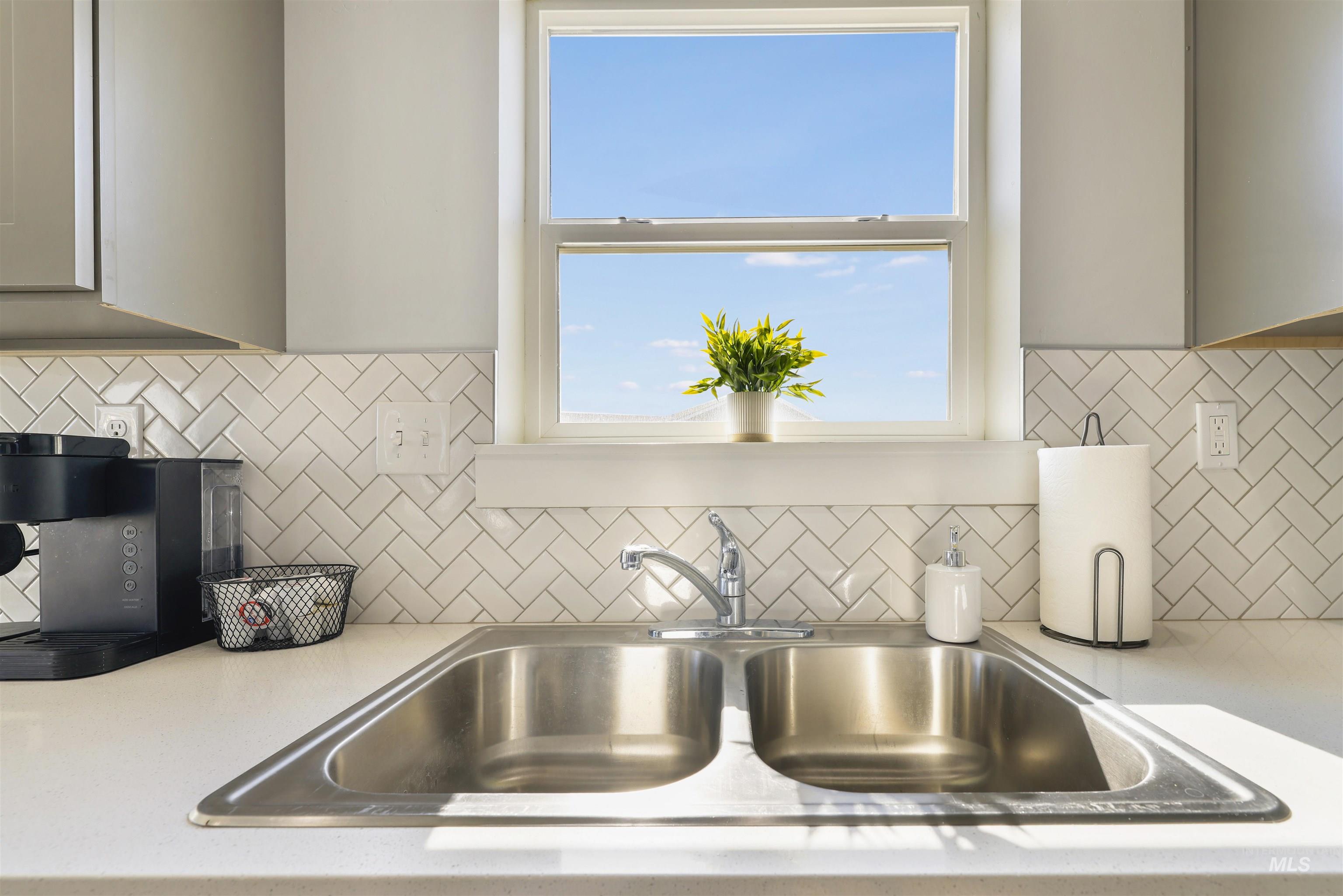 893-899 Shadowleaf Avenue Twin Falls, ID 83301 - Photo 24 of 50 Kitchen view of light countertops, gray cabinetry, and decorative backsplash