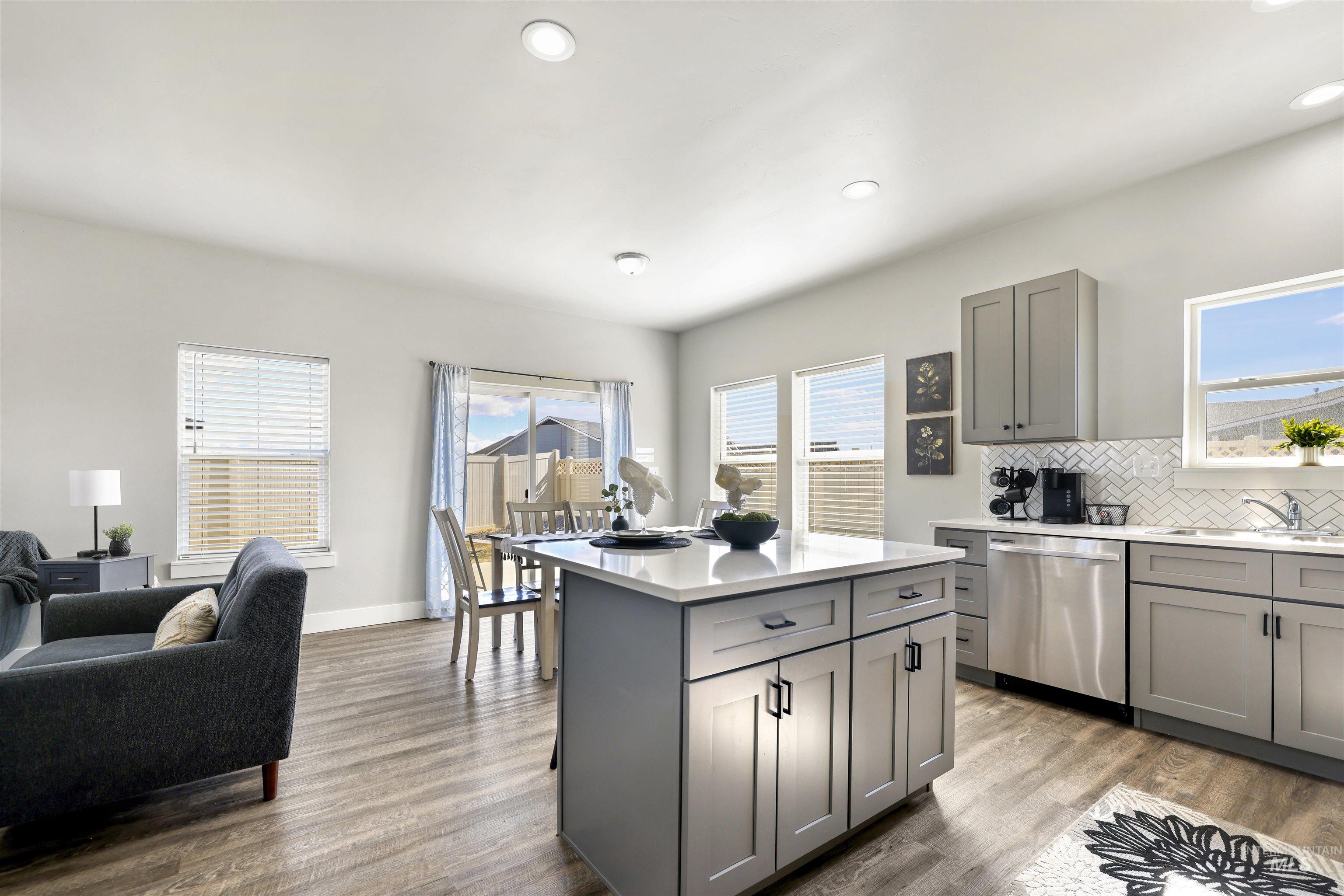 893-899 Shadowleaf Avenue Twin Falls, ID 83301 - Photo 26 of 50 Kitchen featuring gray cabinetry, dark wood finished floors, decorative backsplash, dishwasher, and recessed lighting