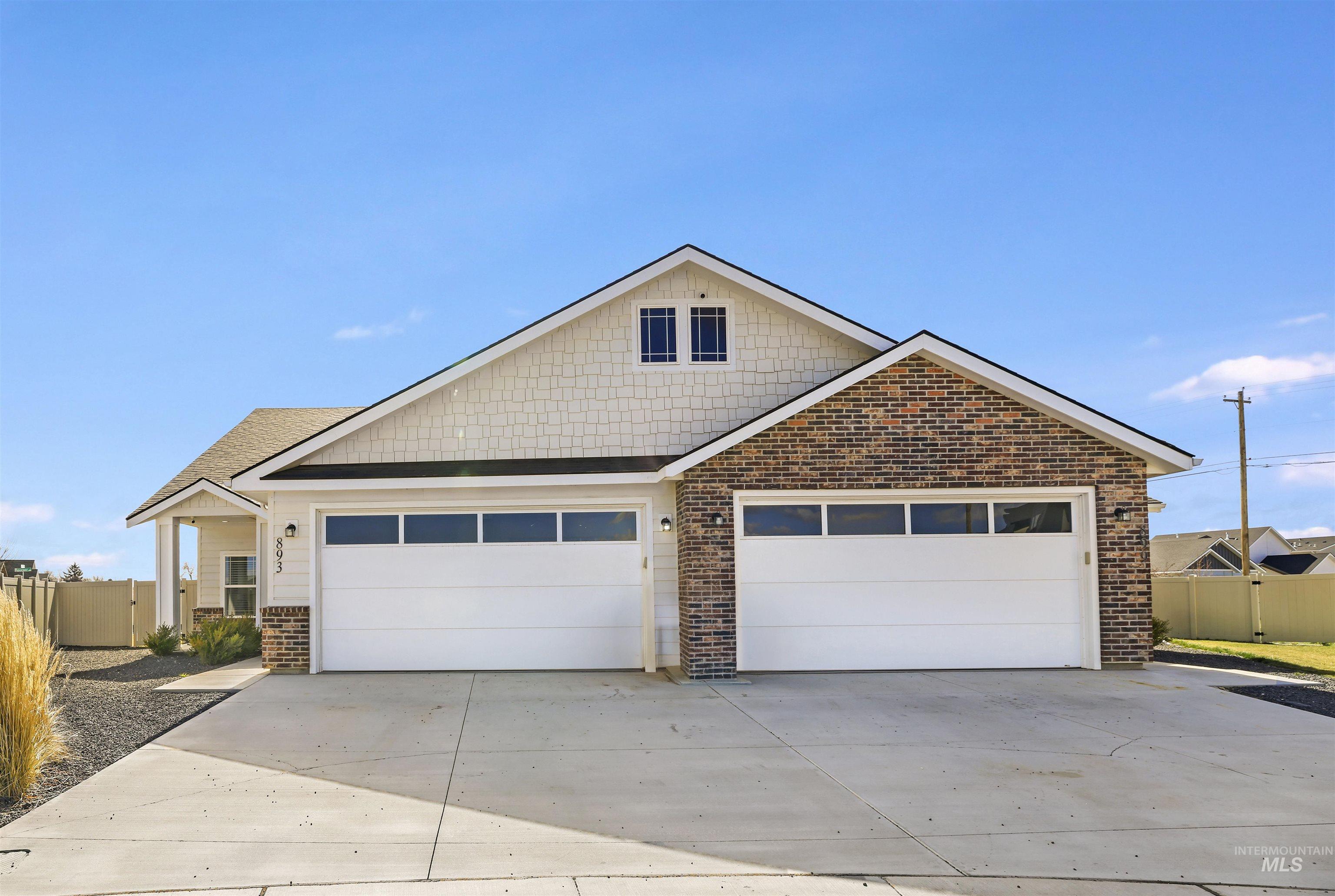 893-899 Shadowleaf Avenue Twin Falls, ID 83301 - Photo 42 of 50 View of front of property featuring brick siding, driveway, and a gate