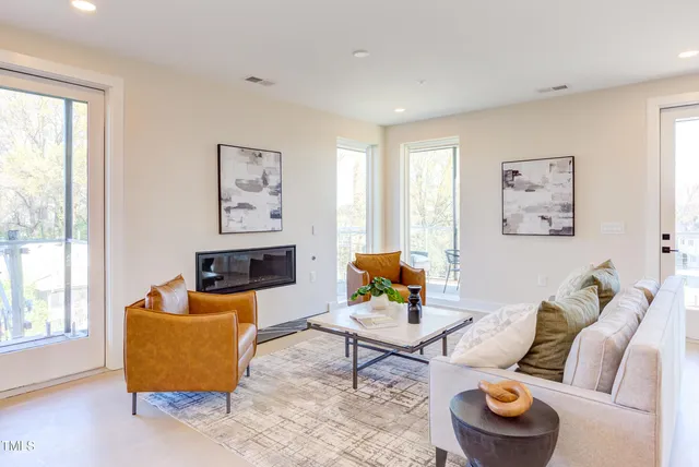 a kitchen with stainless steel appliances granite countertop a sink a stove a refrigerator and a wooden floor