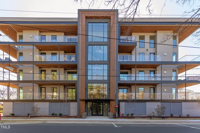 a living room with furniture a fireplace and a chandelier