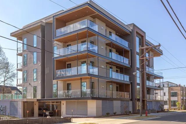 a dining room with furniture a chandelier and wooden floor