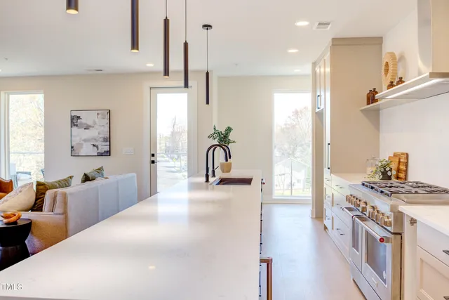 a view of kitchen with sink refrigerator and cabinets