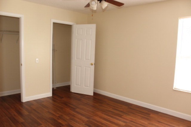 249 Callaway Road Forsyth, GA 31029 - Photo 11 of 13 a view of an empty room with wooden floor and a window