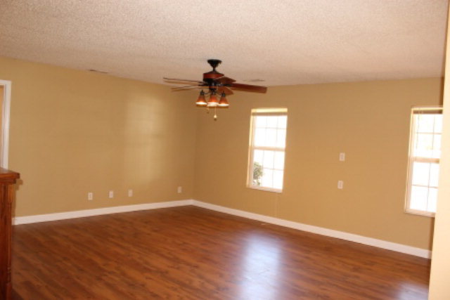 249 Callaway Road Forsyth, GA 31029 - Photo 4 of 13 wooden floor in an empty room with a window
