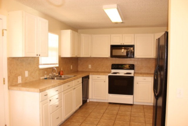249 Callaway Road Forsyth, GA 31029 - Photo 5 of 13 a kitchen with a stove a sink and a microwave