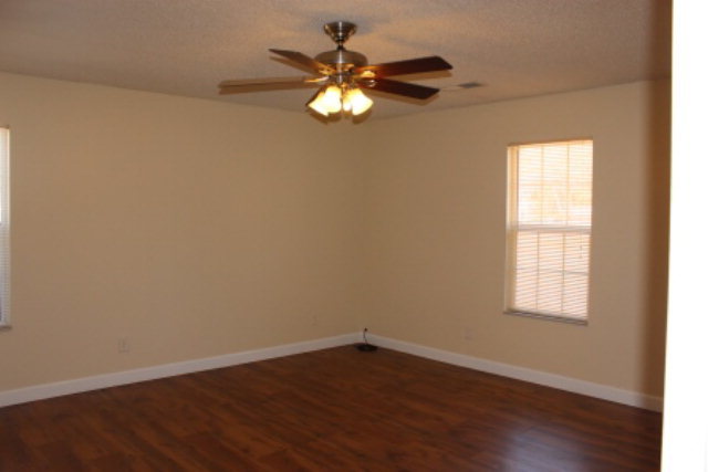 249 Callaway Road Forsyth, GA 31029 - Photo 7 of 13 a view of an empty room with wooden floor and a window