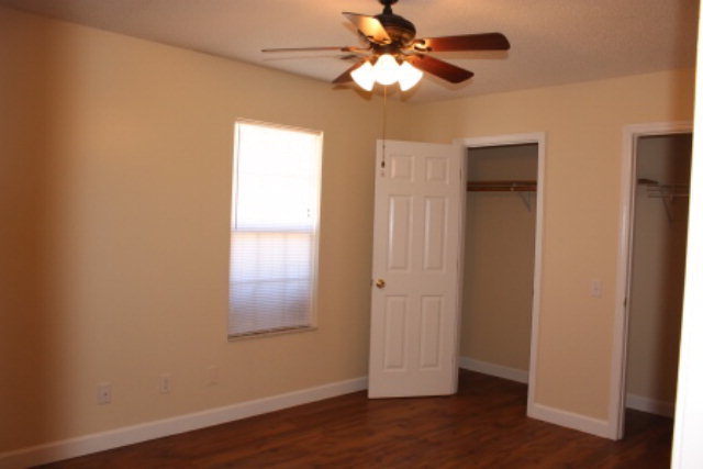 249 Callaway Road Forsyth, GA 31029 - Photo 10 of 13 an empty room with wooden floor closet and fan