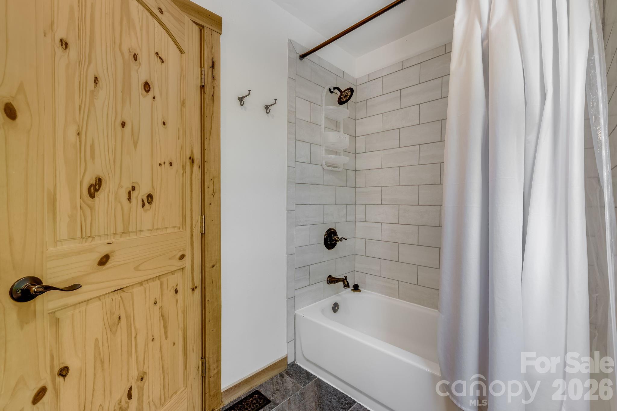 694 Boulder Road Marshall, NC 28753 - Photo 20 of 44 a bathroom with a bathtub a shower and a sink