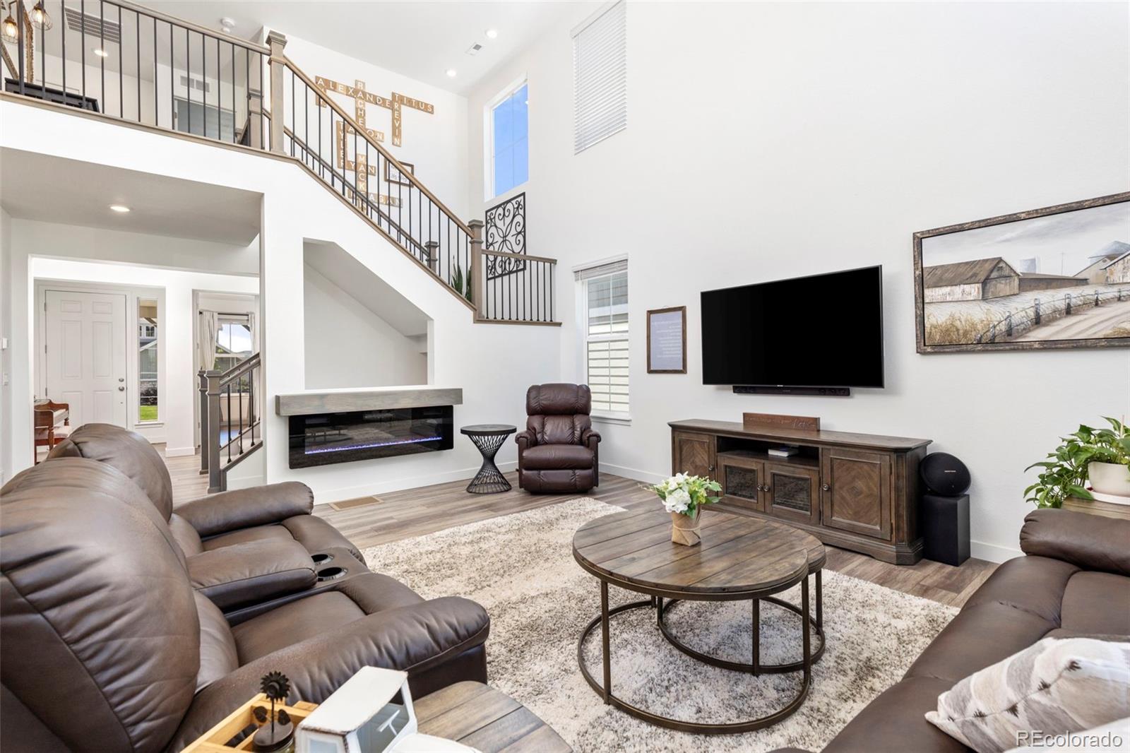 5067 Preserve Place Firestone, CO 80504 - Photo 18 of 50 a living room with furniture and a flat screen tv