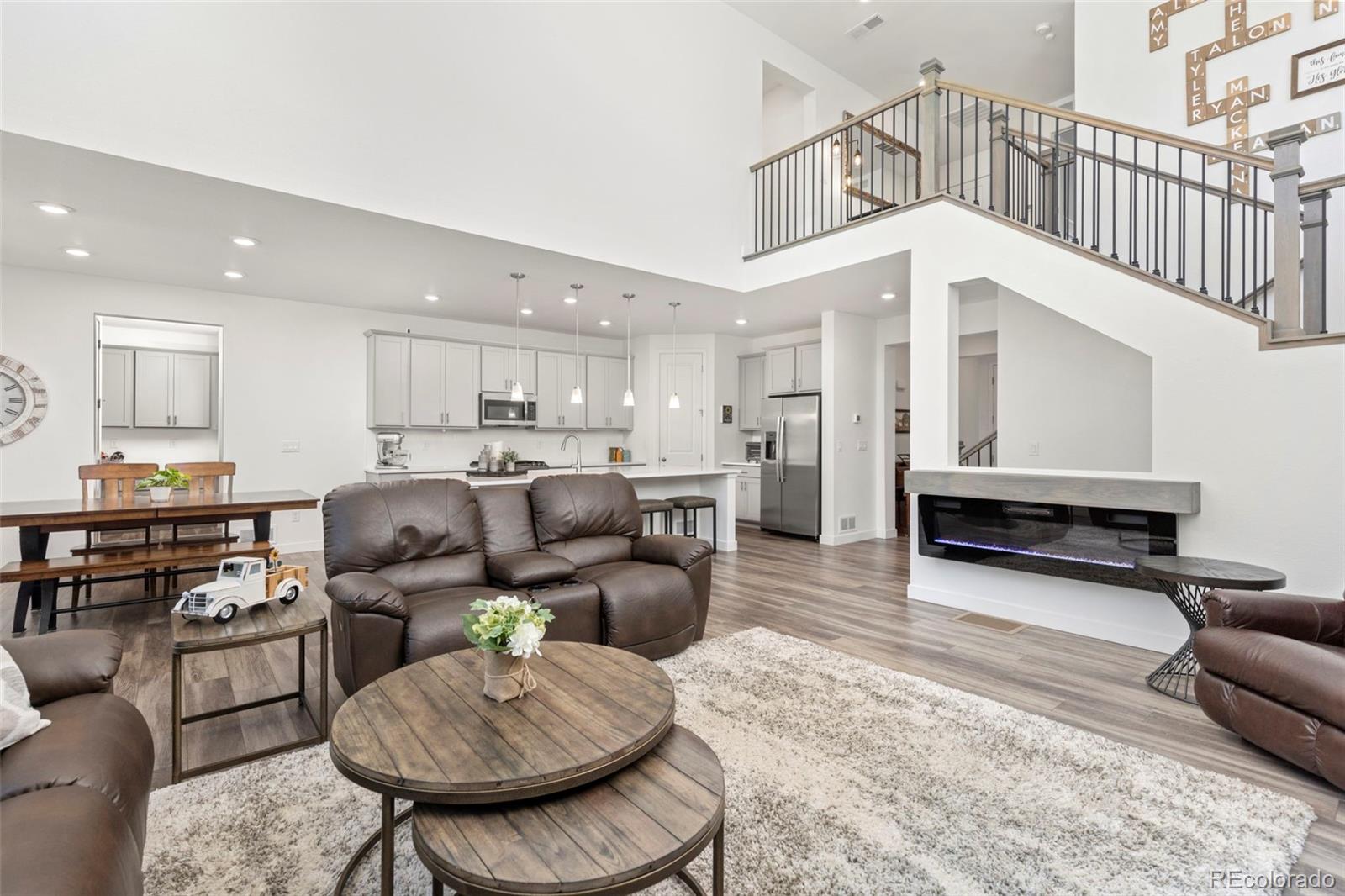 5067 Preserve Place Firestone, CO 80504 - Photo 19 of 50 a living room kitchen with furniture and a dining table