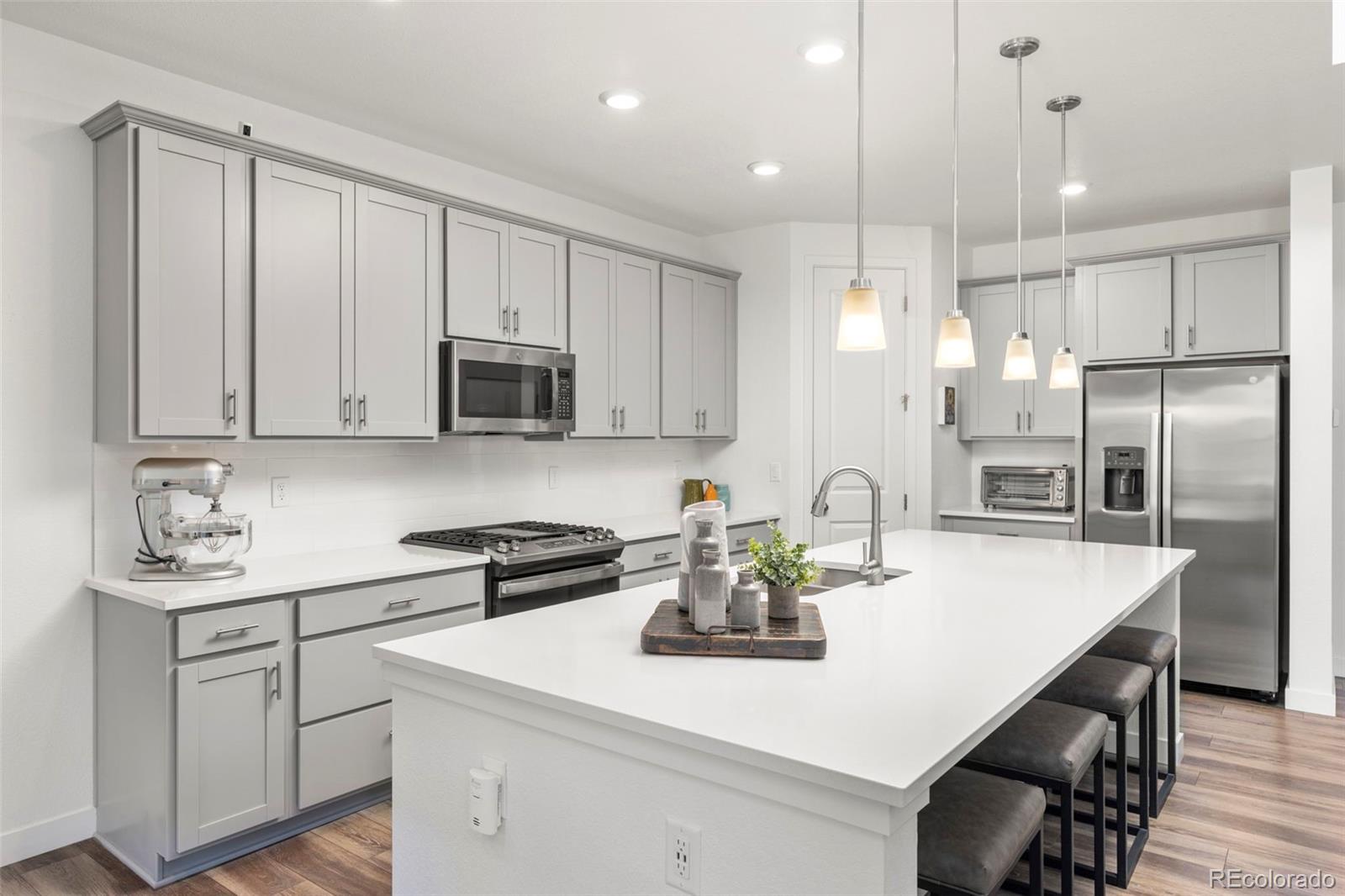 5067 Preserve Place Firestone, CO 80504 - Photo 22 of 50 a kitchen with a sink a microwave and refrigerator