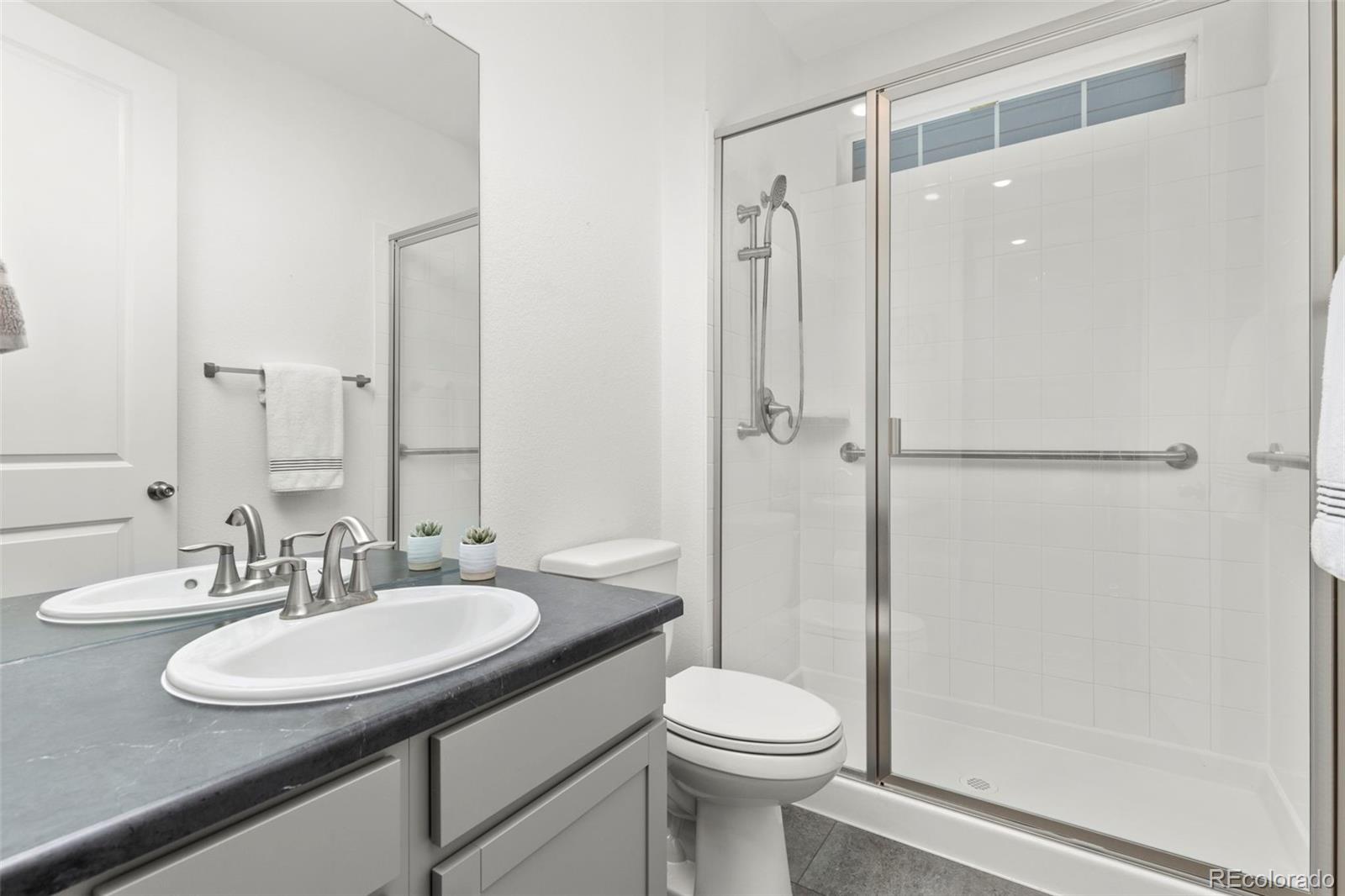 5067 Preserve Place Firestone, CO 80504 - Photo 27 of 50 a bathroom with a sink a toilet and shower