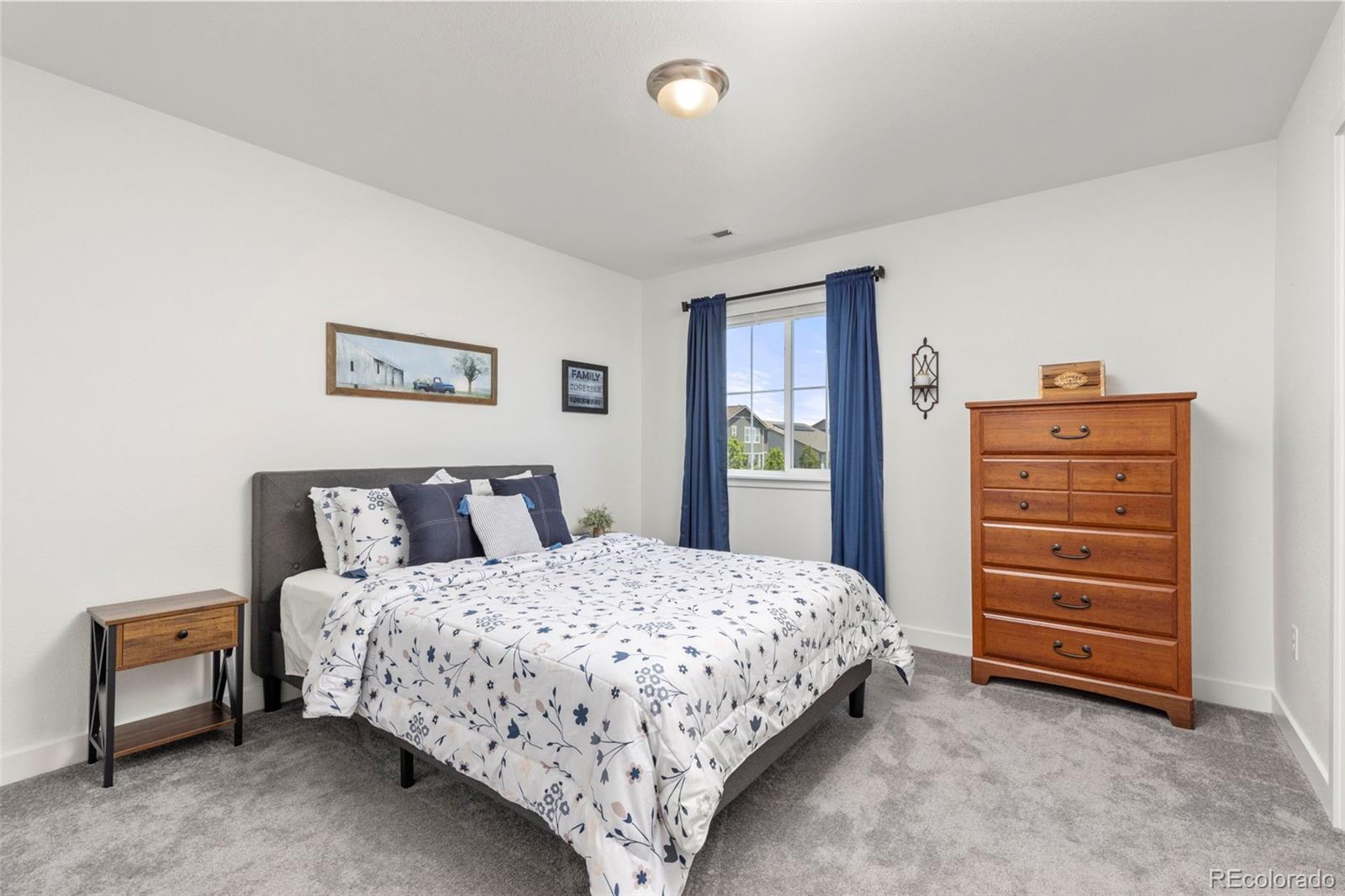 5067 Preserve Place Firestone, CO 80504 - Photo 34 of 50 a bedroom with a bed and a dresser