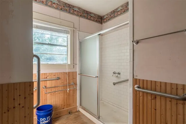 a bathroom with a shower and a window