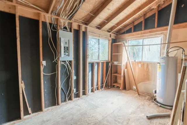 a view of a room with wooden floor and windows
