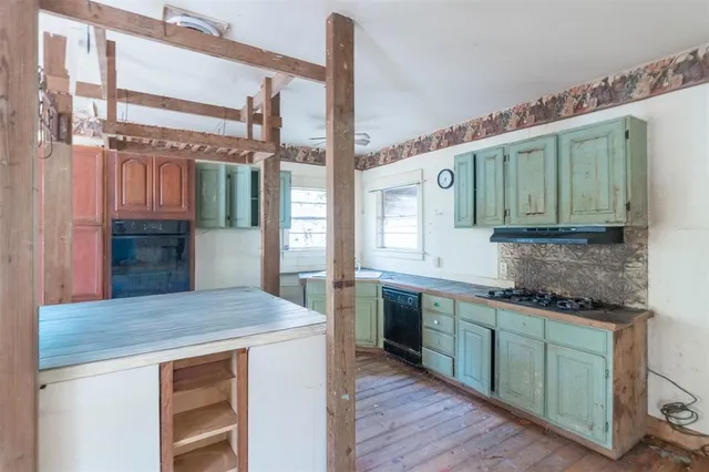 a kitchen with a sink and cabinets