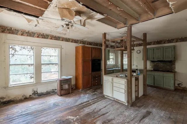 a kitchen with stainless steel appliances granite countertop a refrigerator and a stove